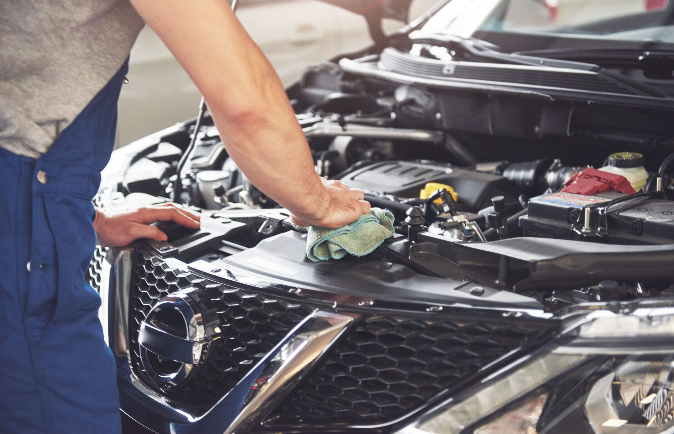 muscular car service worker repairing vehicle (1)